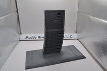 Load image into Gallery viewer, Display Stand for M4 / AR-15 Airsoft AEGs Easily store or display your Airsoft gun Compatible with most Airsoft rifles that uses regular M4 / M16 Airsoft AEG Magazines EMG Logo printed on stand These 3D printed items may need some sanding and could be rough from the printing process, the roughness will not hinder functionality.